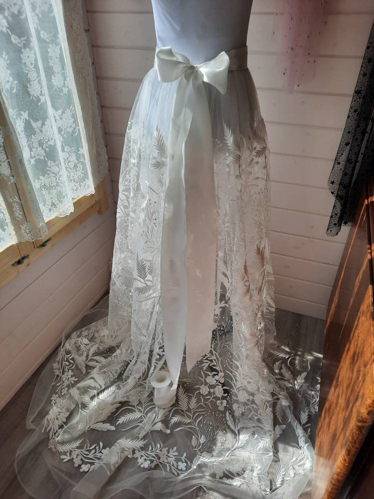 Floral bridal overskirt in off-white. Embroidered tulle with trailing flowers and leaves, perfect for a winter wedding.