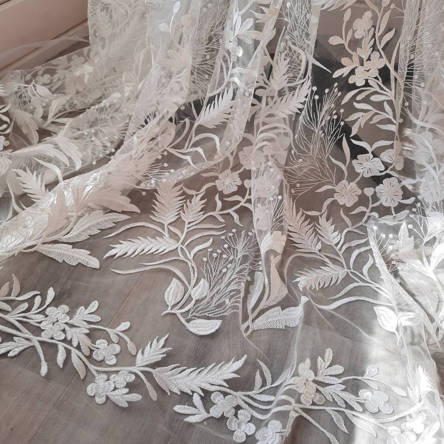 Floral bridal overskirt in off-white. Embroidered tulle with trailing flowers and leaves, perfect for a winter wedding.