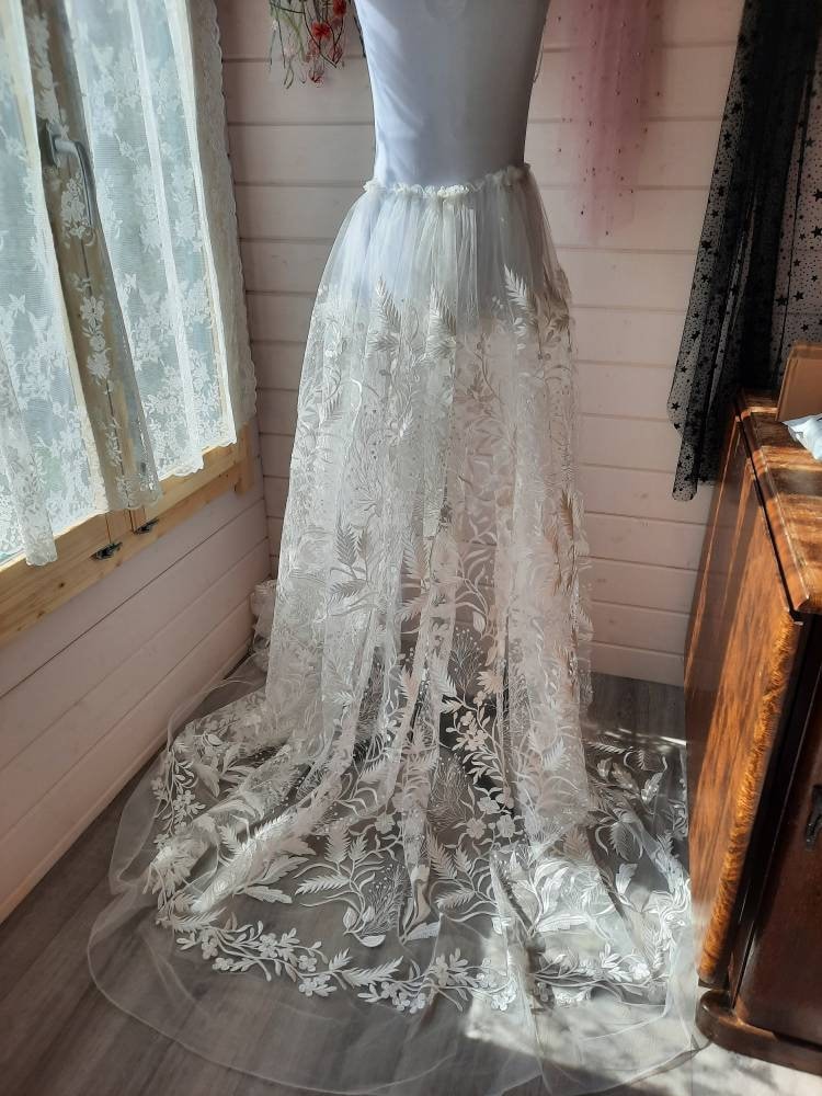 Floral bridal overskirt in off-white. Embroidered tulle with trailing flowers and leaves, perfect for a winter wedding.